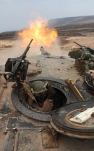 Lance Cpl. William Laffoon, tank crewman with Tank platoon Alpha Company, Battalion Landing Team 1st Battalion, 9th Marine Regiment, 24th Marine Expeditionary Unit, braces himself after firing a 120mm round from a M1A1 Abrams battle tank during a live-fire range in Djibouti, Africa March 30.  Marine tank crewmen engaged several targets alongside the French 13th Foreign Legion Demi-Brigade as part a joint exercise.  The 24th MEU is currently serves as the theatre reserve force for Central Command during its seven month deployment aboard Nassau Amphibious Ready Group vessels.  (U.S. Marine Corps photo by Sgt. Alex C. Sauceda)